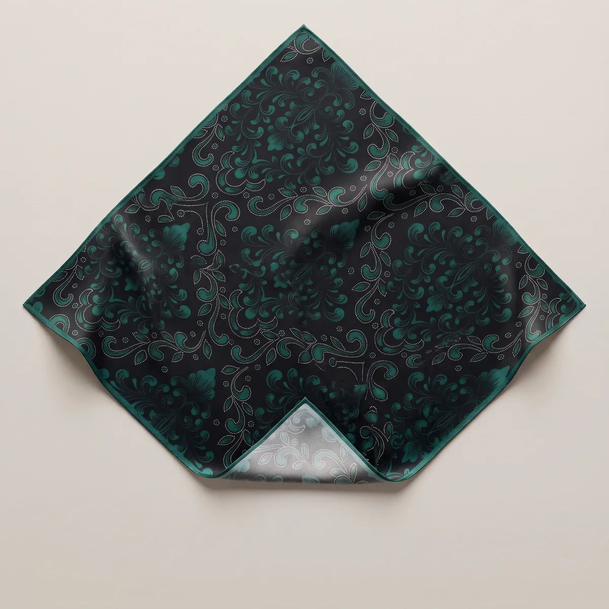 Black and dark teal baroque silk bandana laid flat as a diamond, muted teal scrollwork on black, teal edge
