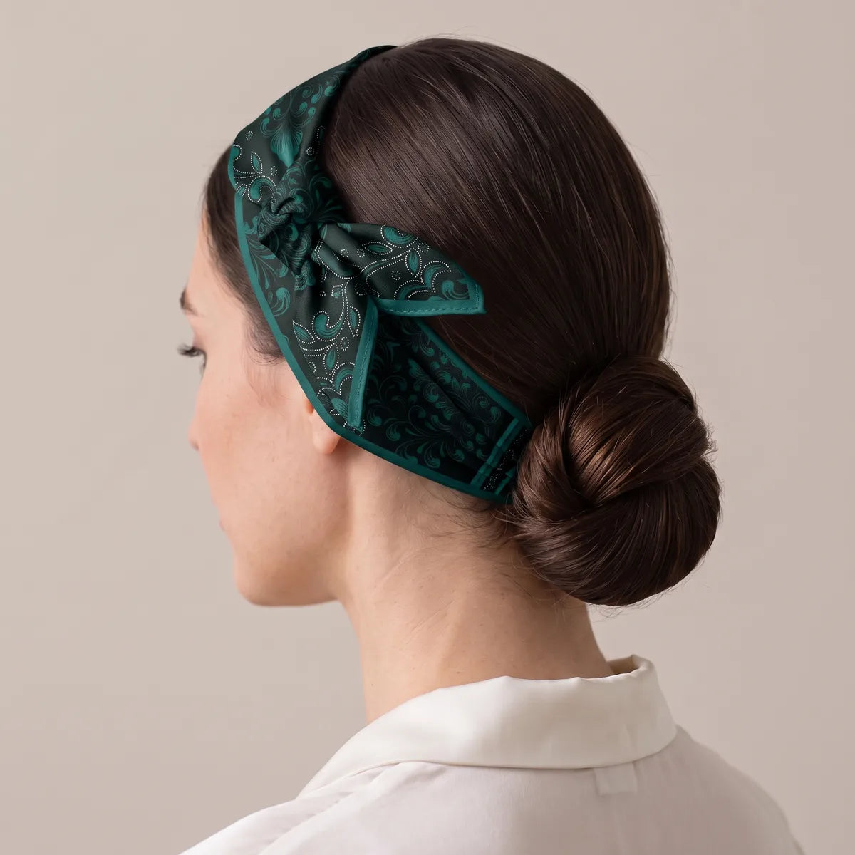 Black baroque silk bandana as a narrow headband, the knot above the ear, low bun at the back