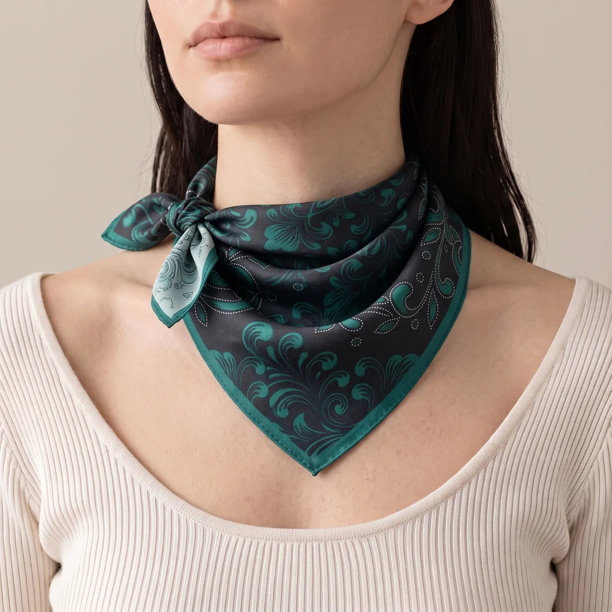 Black and dark teal baroque silk bandana knotted slightly to one side of the neck, over a white ribbed top