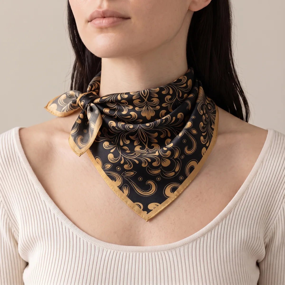 Black baroque silk bandana tied as a neckerchief, knot to the side, worn over a cream top