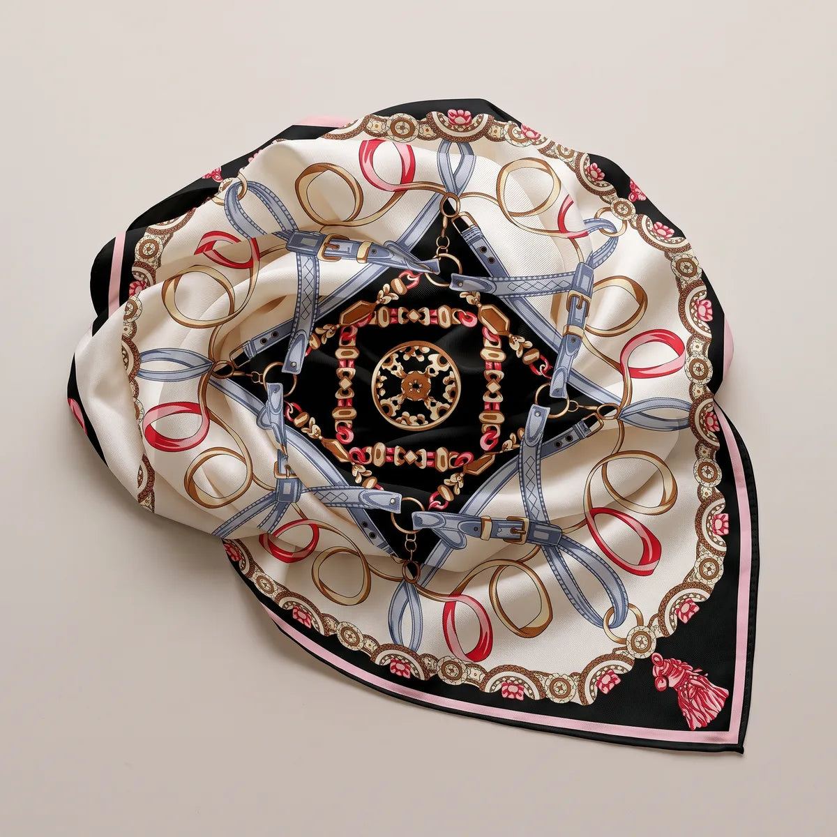 Black and cream chain print shawl laid in a loose round with its edges tucked under, the black star flat at the center