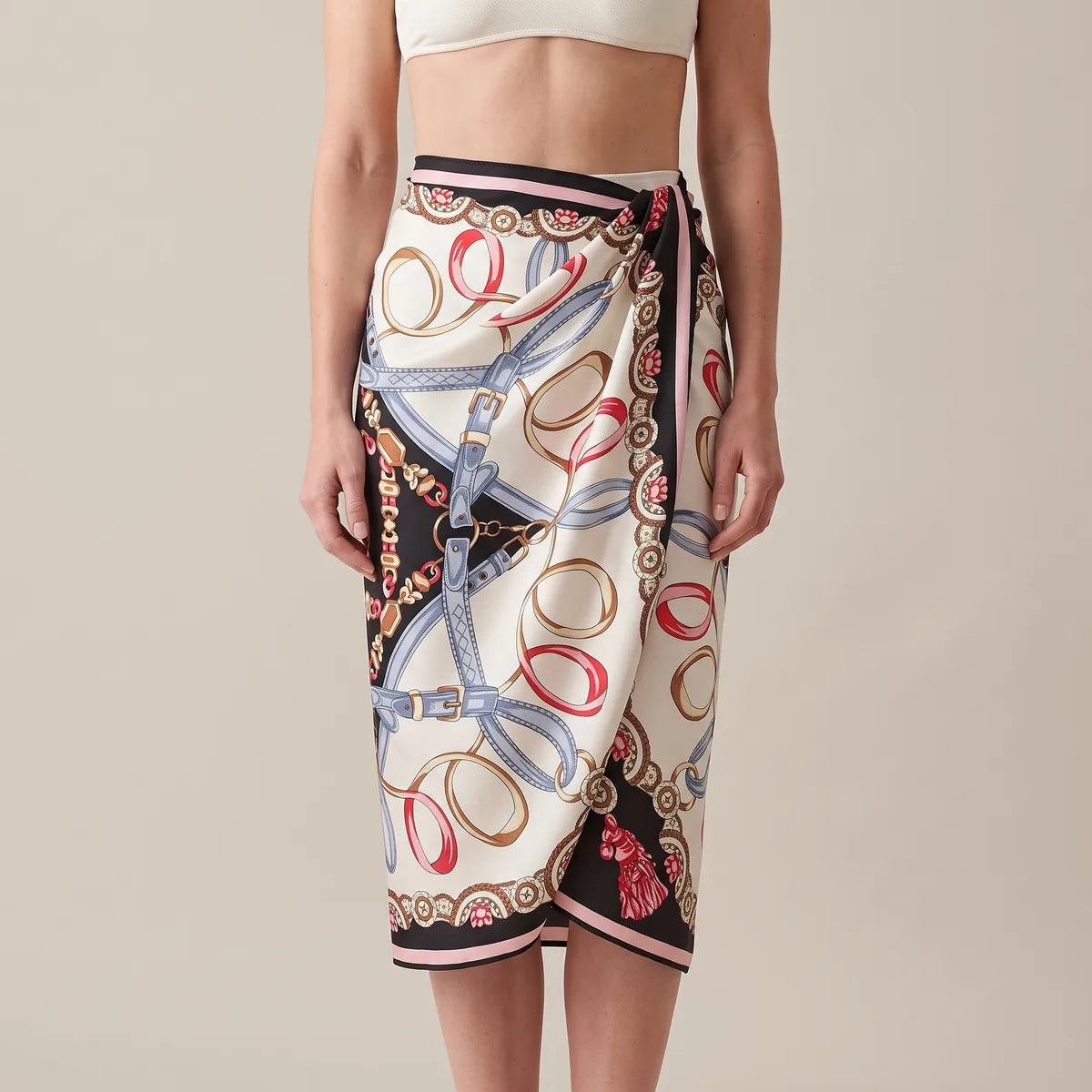 Black and cream silk shawl knotted at one side of the waist as a sarong, its black end hanging down the side