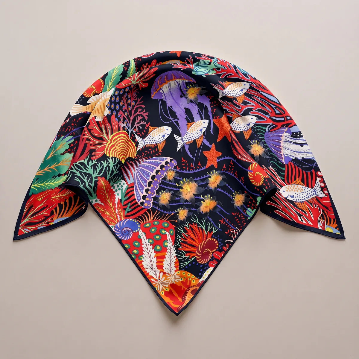 Sea life silk shawl folded into a triangle, a violet jellyfish at the center and a thin black edge along the points
