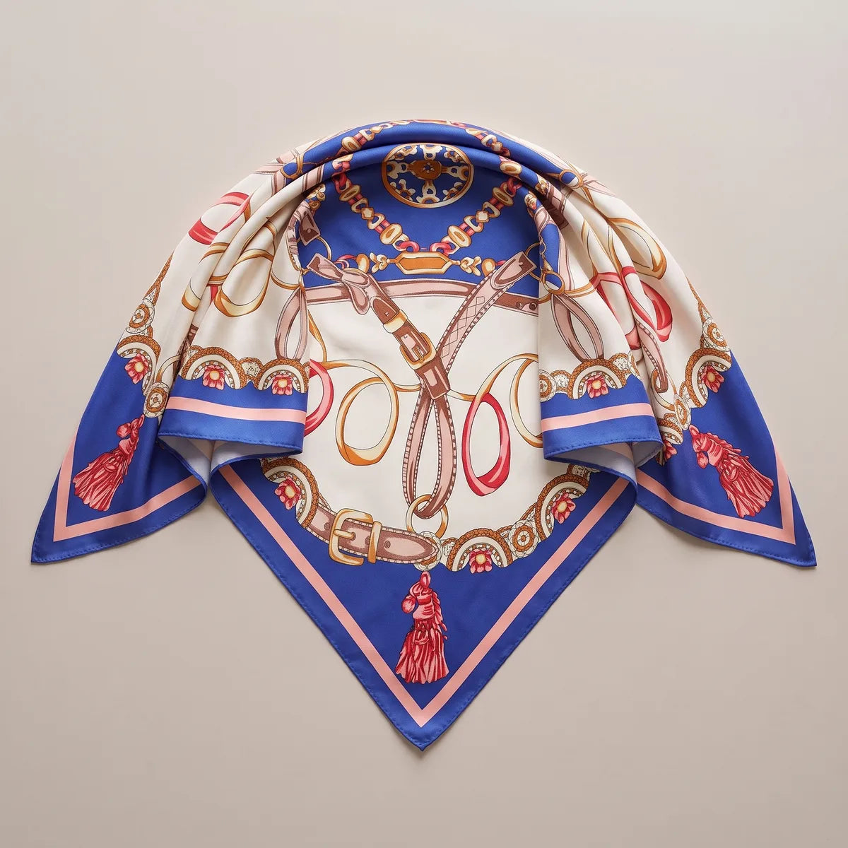 Royal blue and cream silk shawl gathered at the top into a triangle, red horse-head tassels on all three points