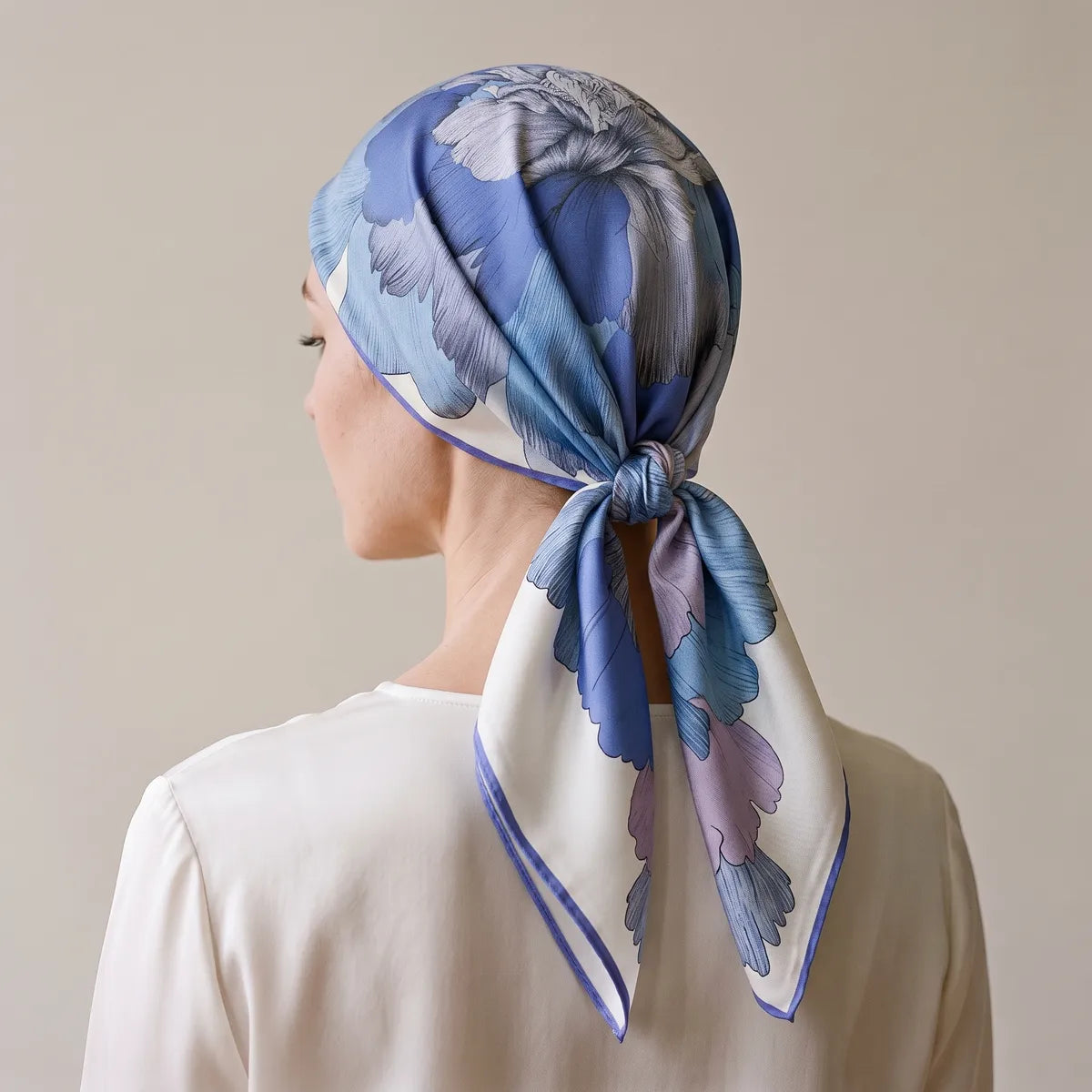 Peony silk square worn over the whole head, seen from behind, knotted at the nape with ends hanging