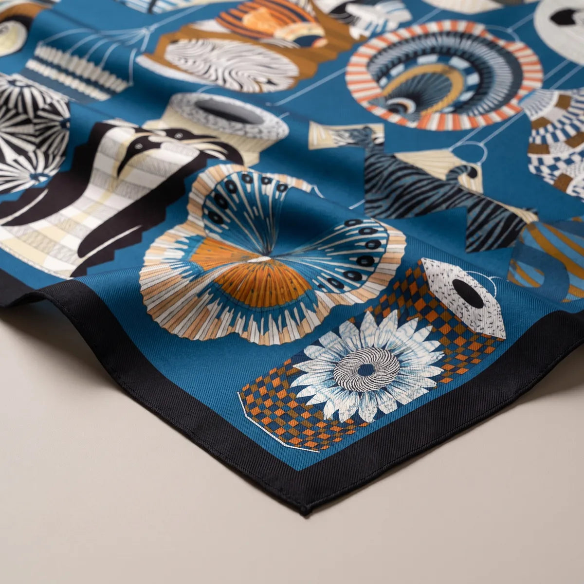 Folds of the blue lantern scarf: a striped fan lantern, a white flower lantern and the navy hem