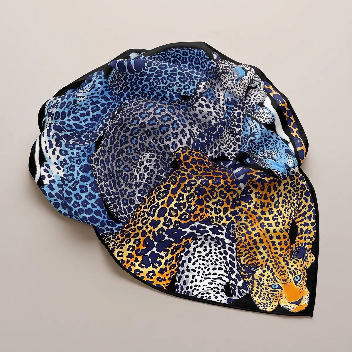 Cobalt and orange leopard shawl gathered in a loose swirl, spotted coats in blue and silver gray