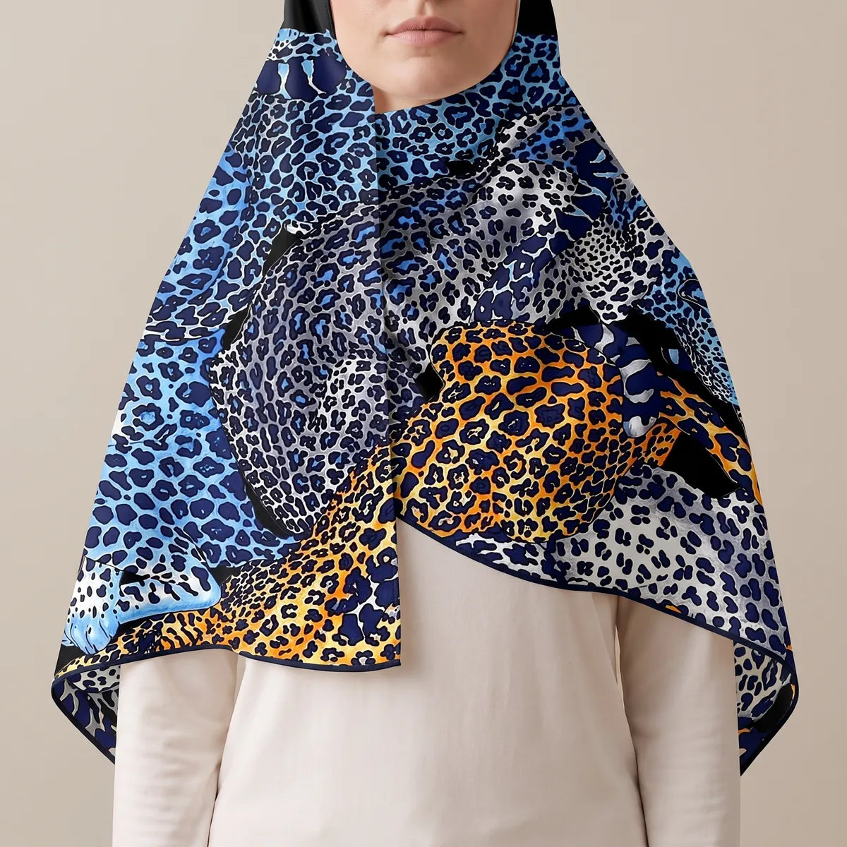 Blue leopard print shawl pulled over the head as a hood, falling open over a cream top