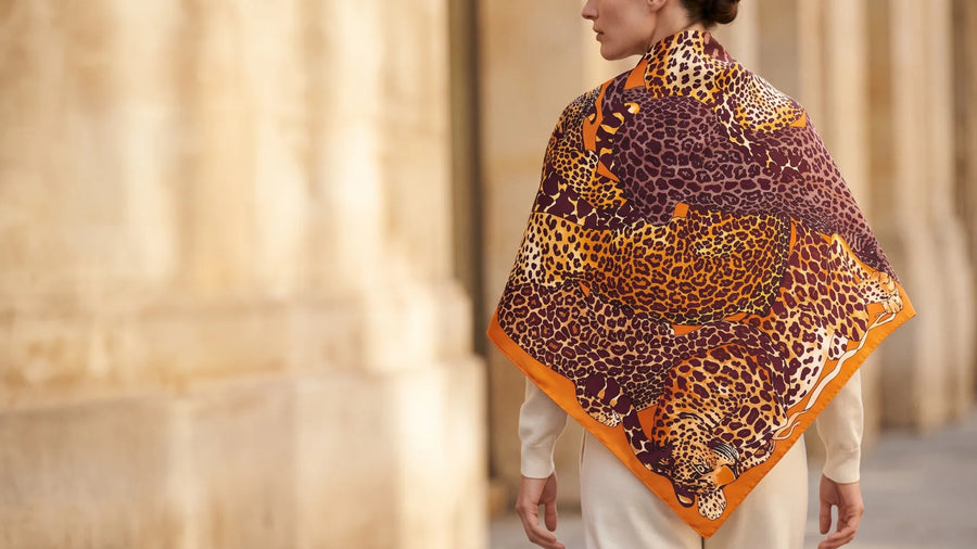Back view of a woman wearing a tawny leopard print silk shawl over her shoulders