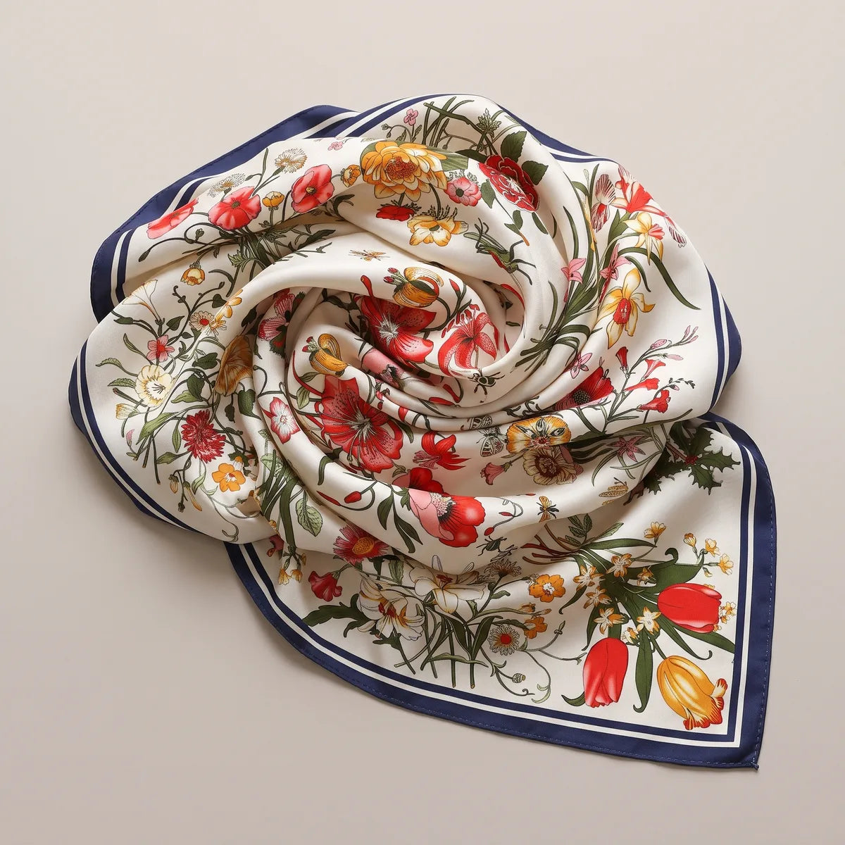 Cream and navy floral shawl swirled into a rose shape, red poppies at the center