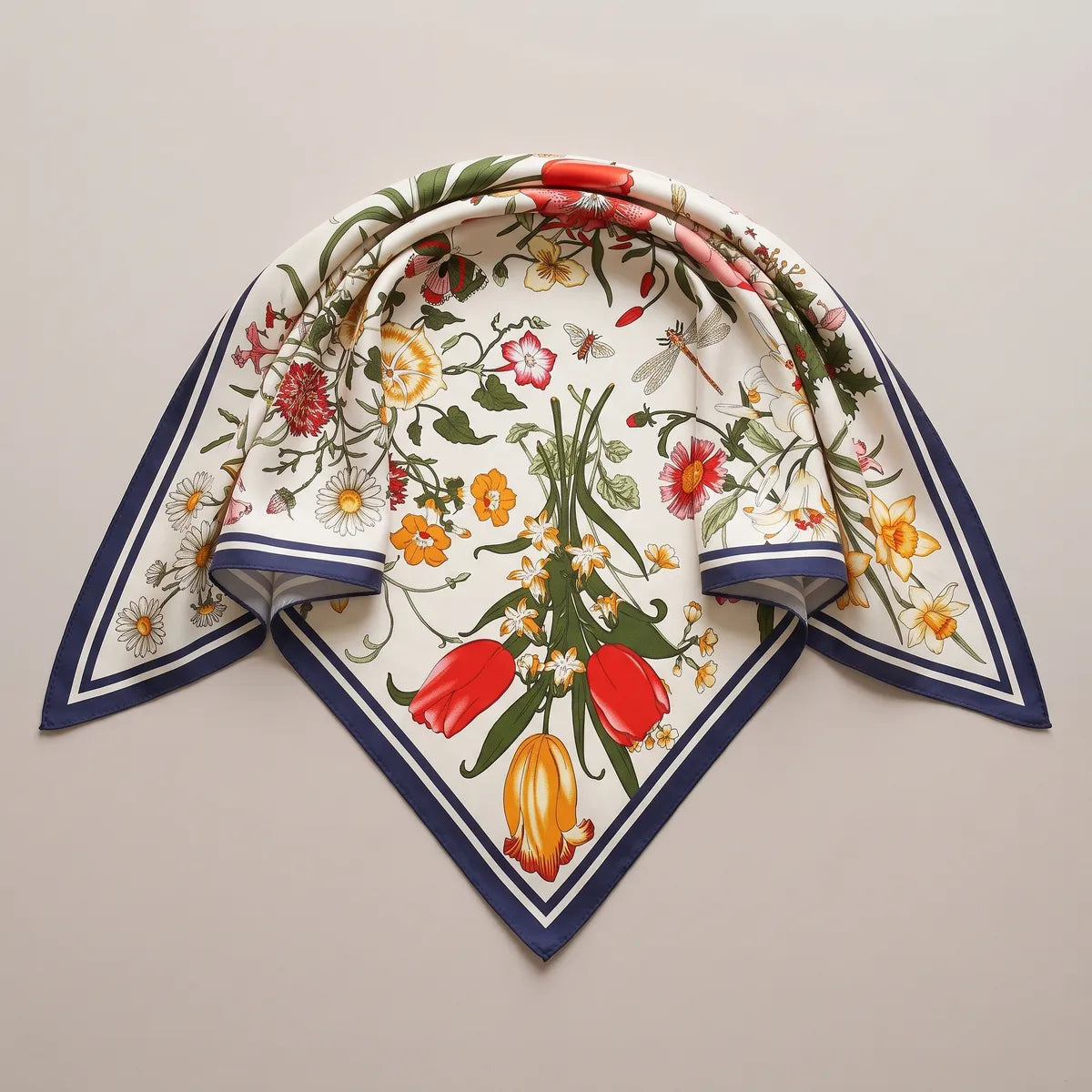 Cream floral silk shawl folded into a triangle, red and yellow tulips at the point