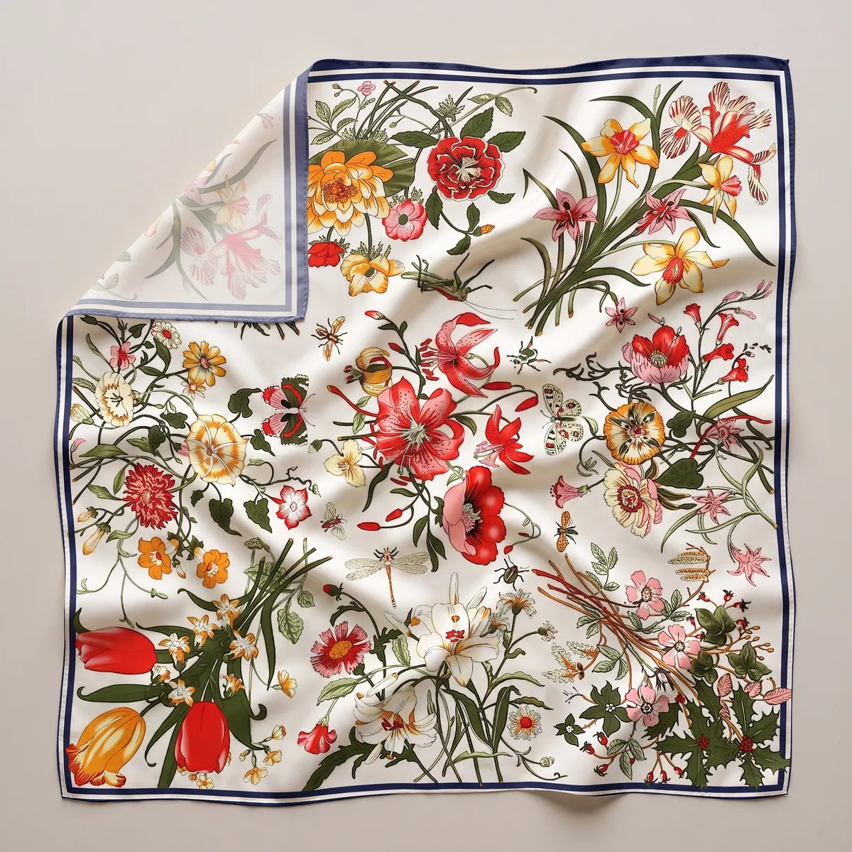 Cream botanical floral silk shawl laid flat: tulips, lilies and poppies in bouquets on cream, navy border