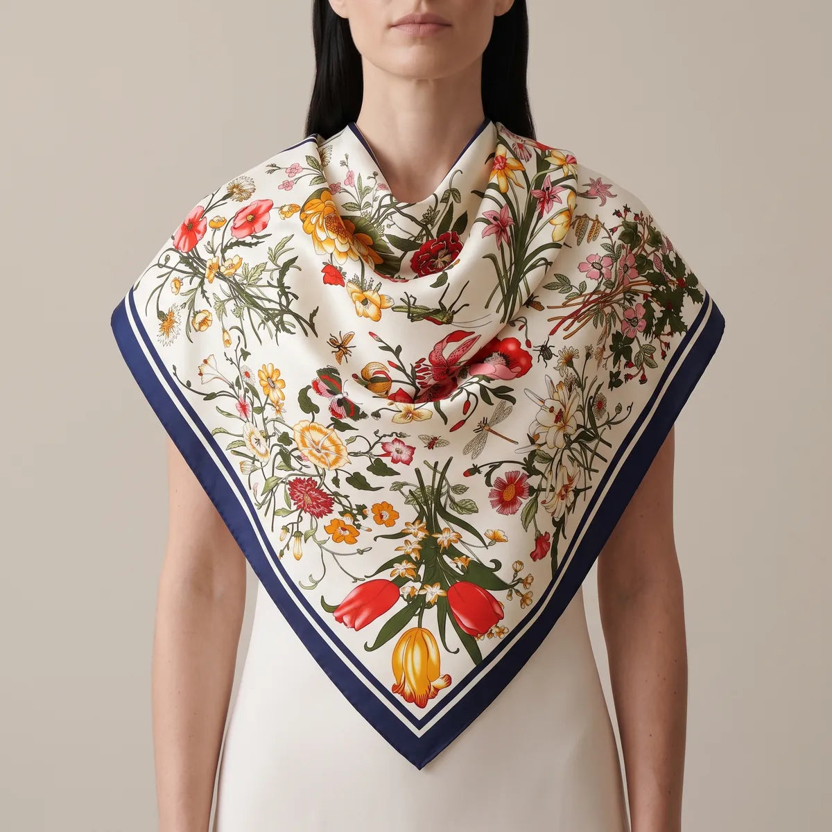 Woman wearing the cream botanical floral shawl over her shoulders, tulips at the front point