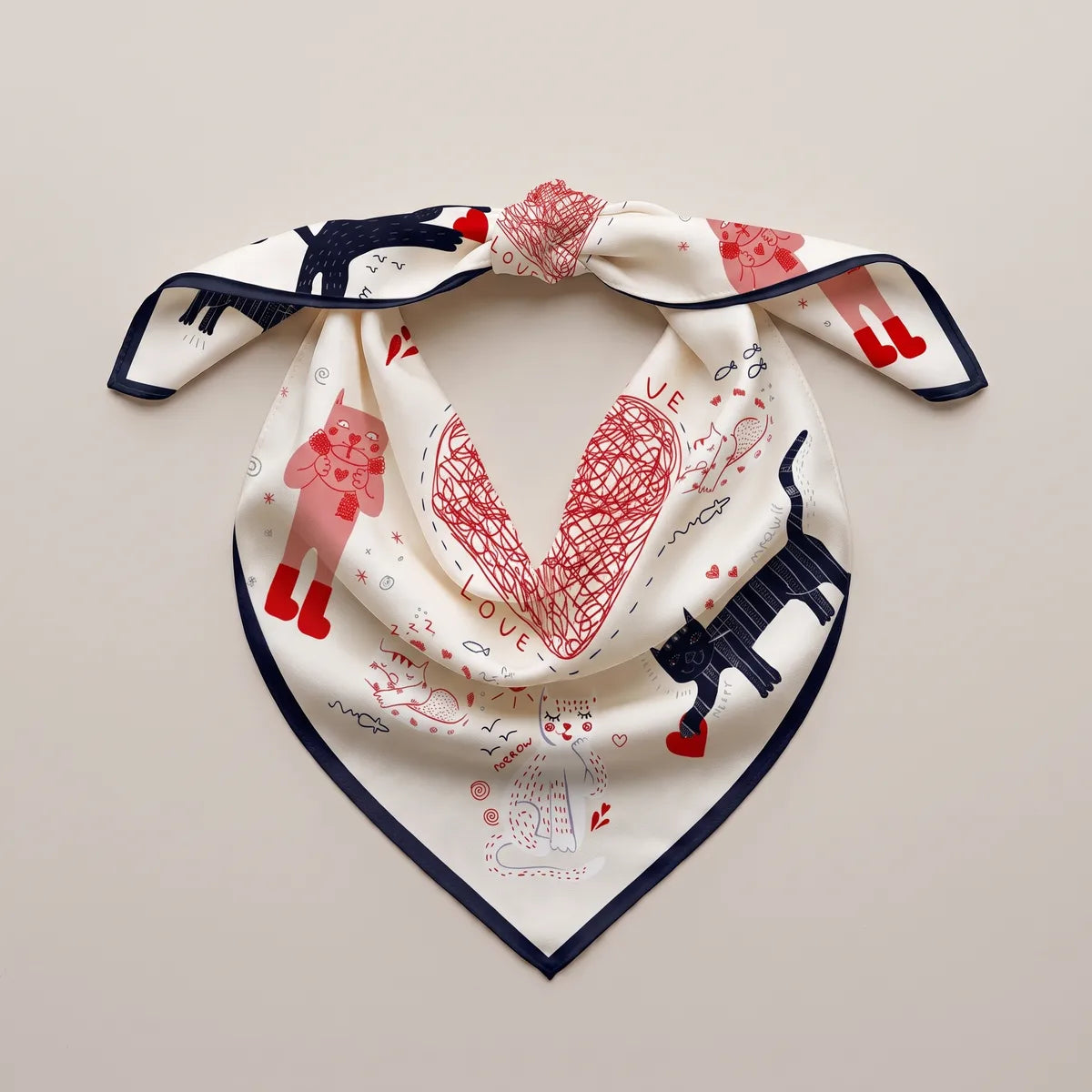 Cream silk bandana knotted into a loop, scribbled heart and a striped navy cat on the triangle
