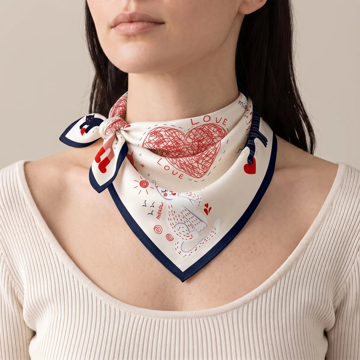 Cream cat print bandana tied at the side of the neck, red heart at the front