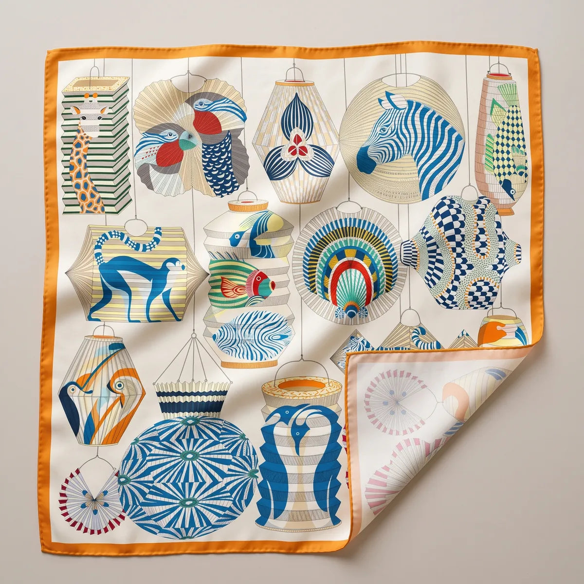 Cream lantern print silk square scarf laid flat: paper lanterns with a zebra, giraffe, monkey and fish, orange border