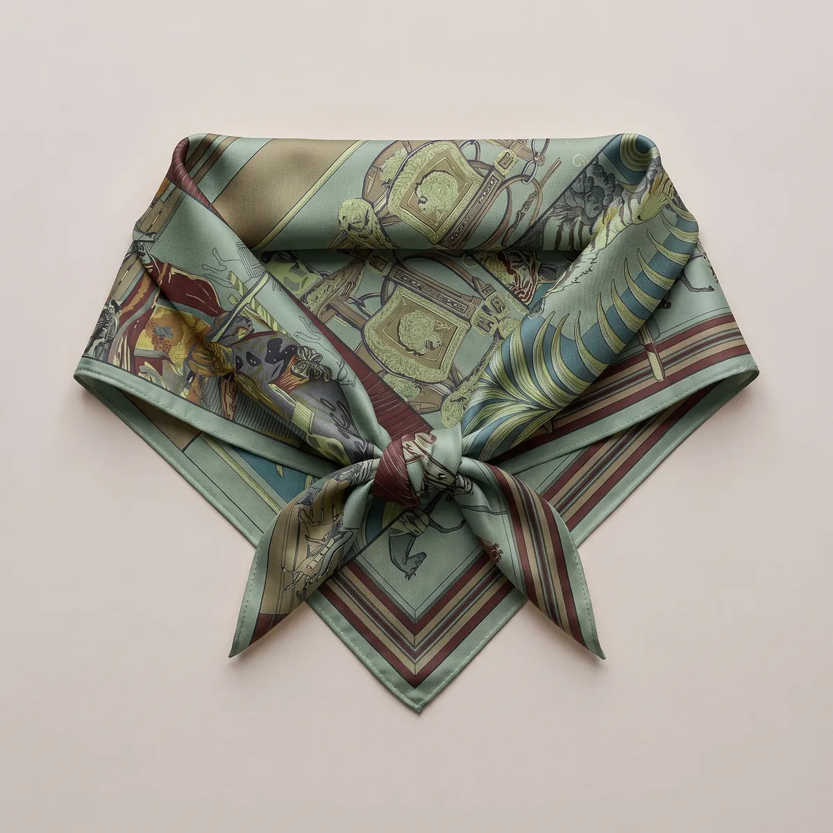 Large silk square tied into a triangle shape, striped burgundy edging at the point below the knot