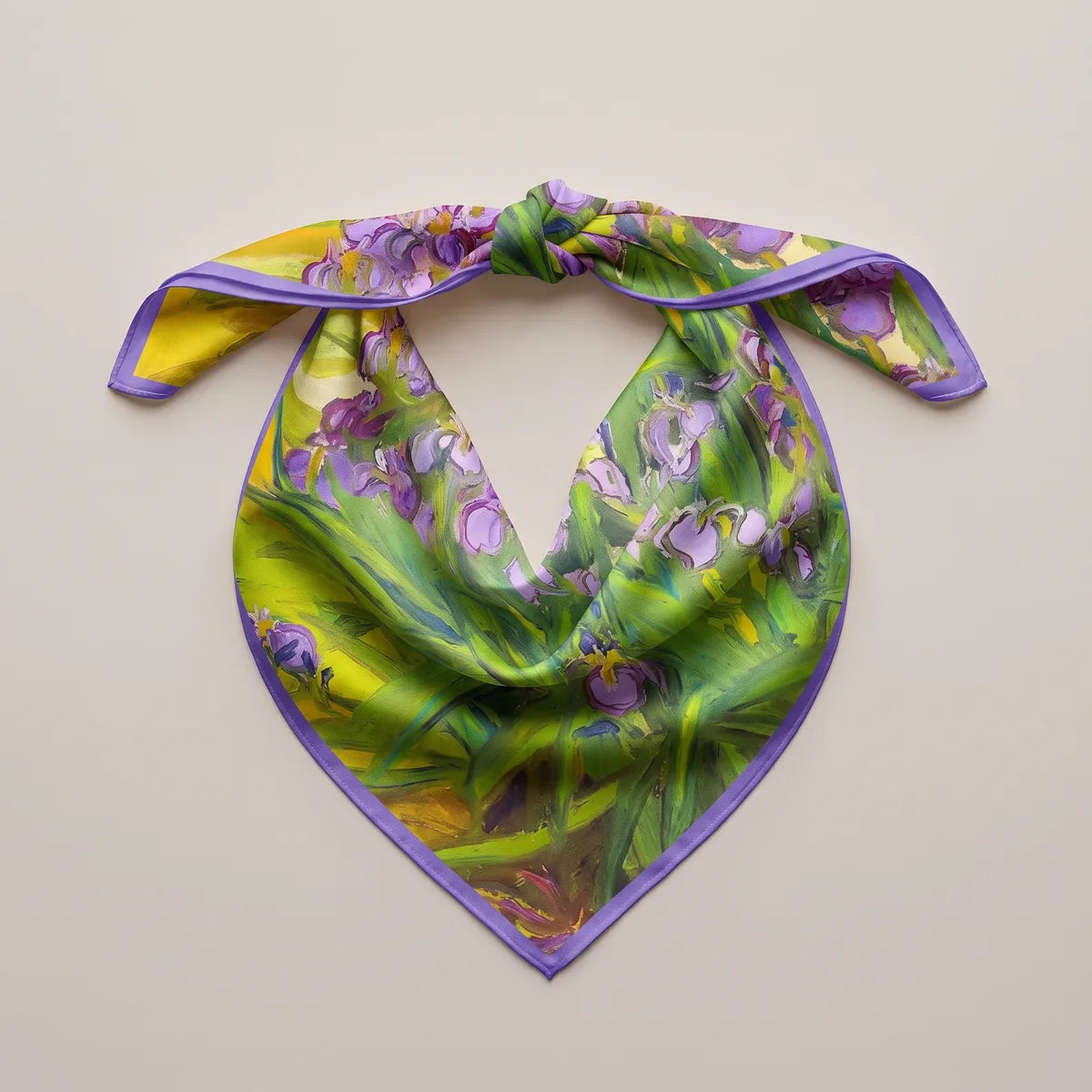 Iris print bandana knotted at the top and spread flat, the painted leaves and flowers hanging in a deep V