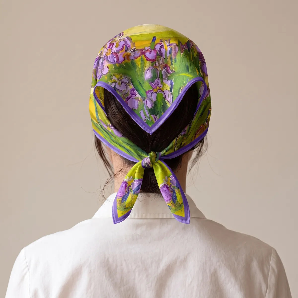 Back view of the iris bandana tied as a kerchief over the hair, knotted at the nape above a white collar