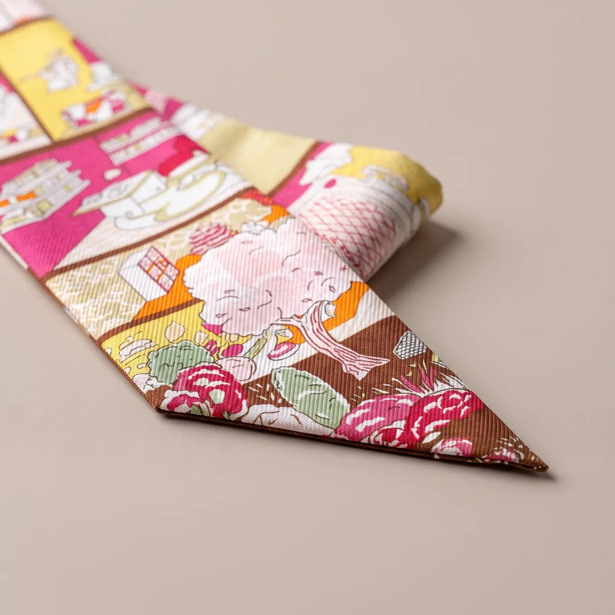 Folded tip of the hot pink skinny scarf: a pink tree, magenta roses and brown ground