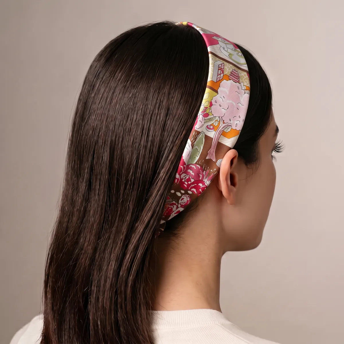 Hot pink skinny scarf worn as a headband on long hair, pink tree on the side