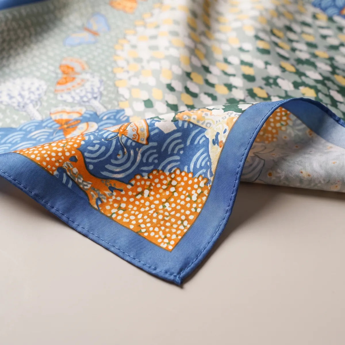 An orange dotted tree on blue waves at the medium blue edge of the butterfly bandana
