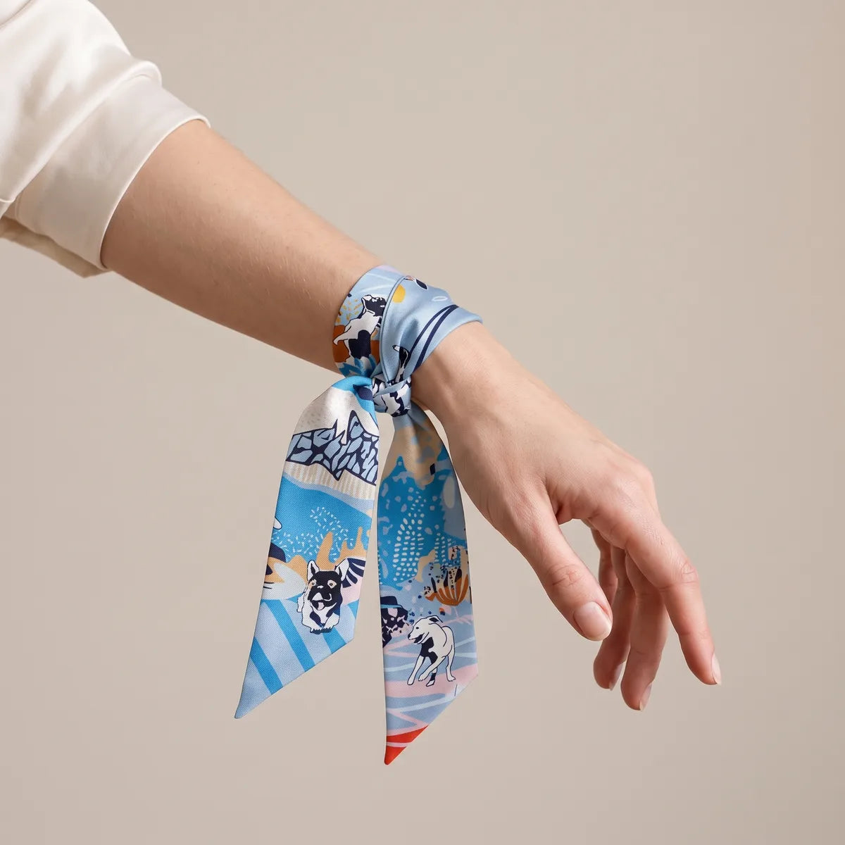 Sky blue terrier skinny scarf tied around the wrist like a cuff