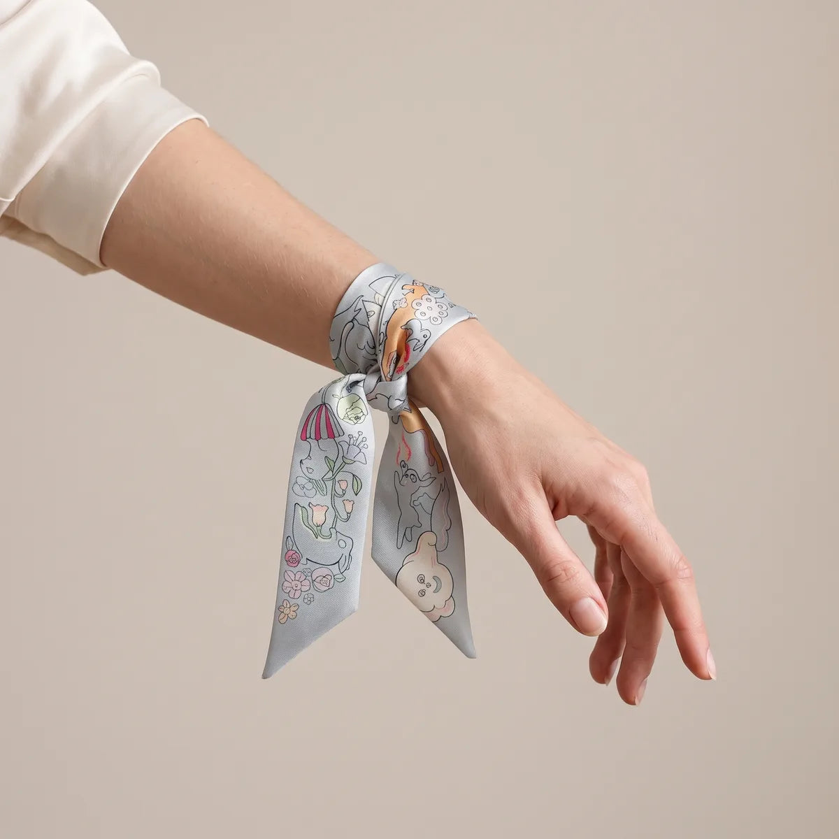 Pastel blue skinny scarf knotted around the wrist, a pink parasol bloom on one hanging end