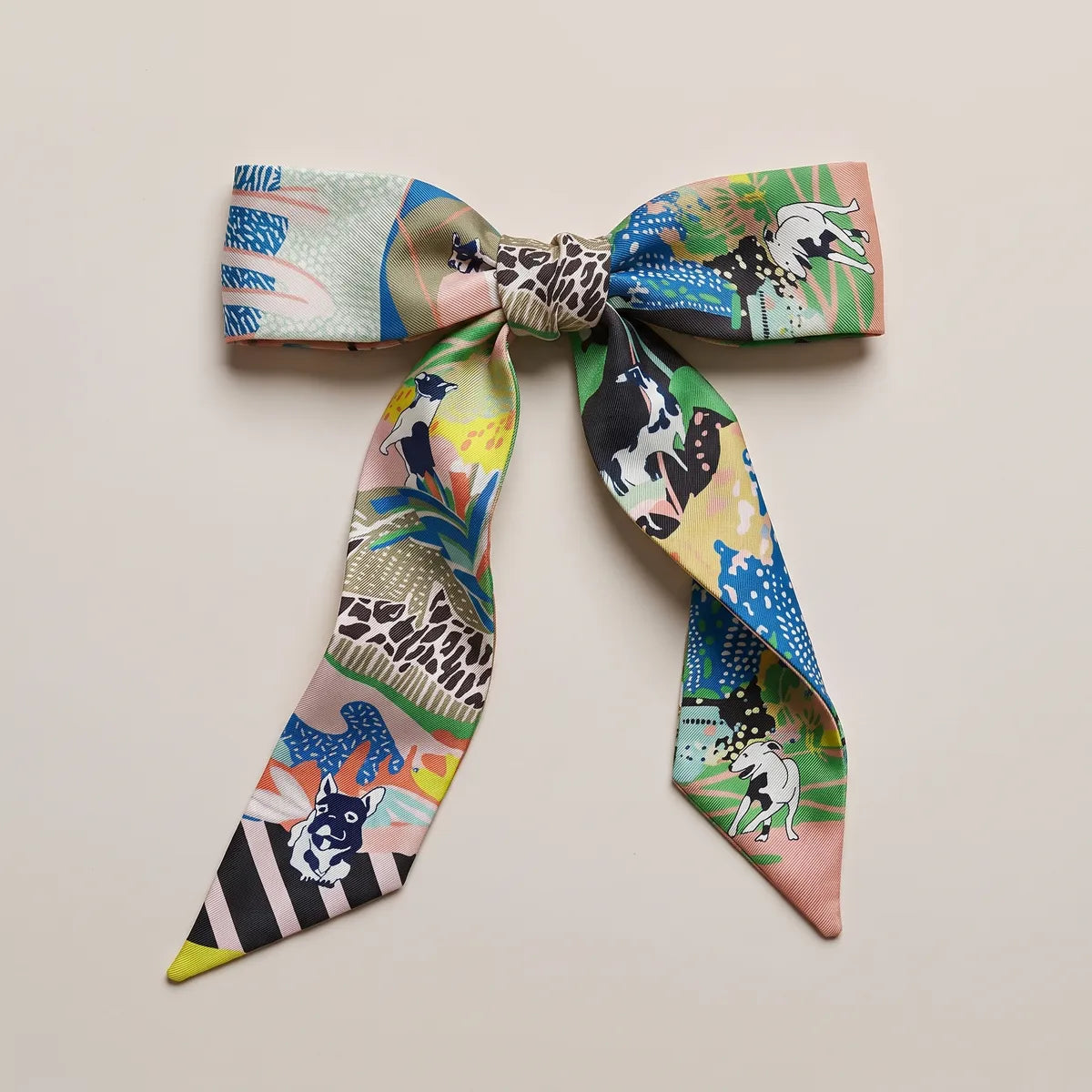 Multicolor skinny silk scarf tied in a bow, leopard spots on the knot and terriers on both loops