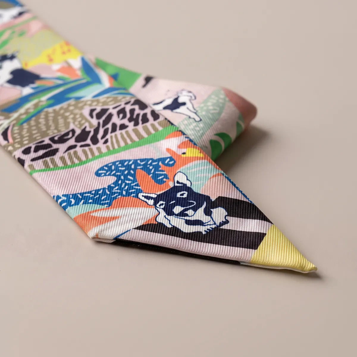 Tip of the multicolor dog skinny scarf: navy terrier face, black and pale pink stripes and a yellow point