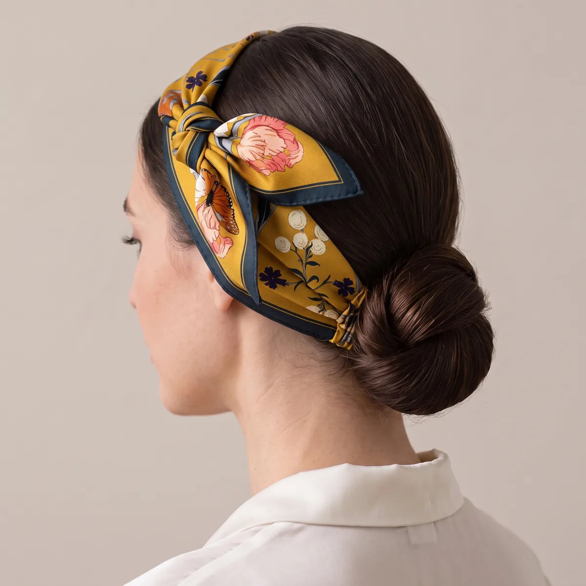 Mustard bandana folded into a headband over a low bun, knot high on the side of the head