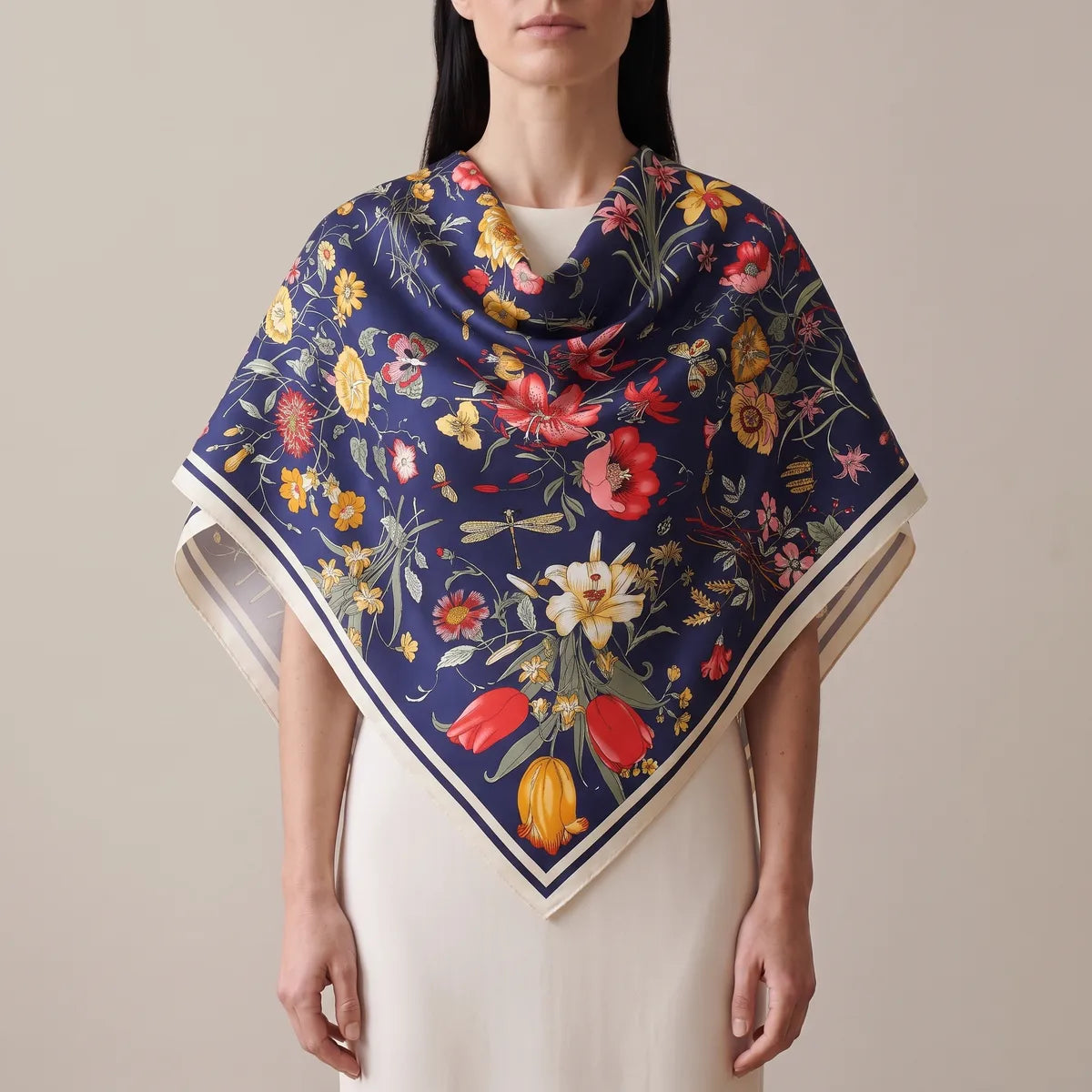 Woman wearing the navy botanical floral silk shawl across her shoulders, cream border at the point