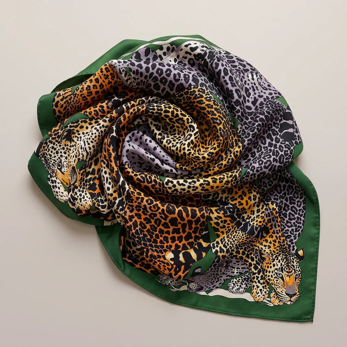 Leopard silk shawl swirled into a rose shape, gray coats on one side and orange on the other, green edge