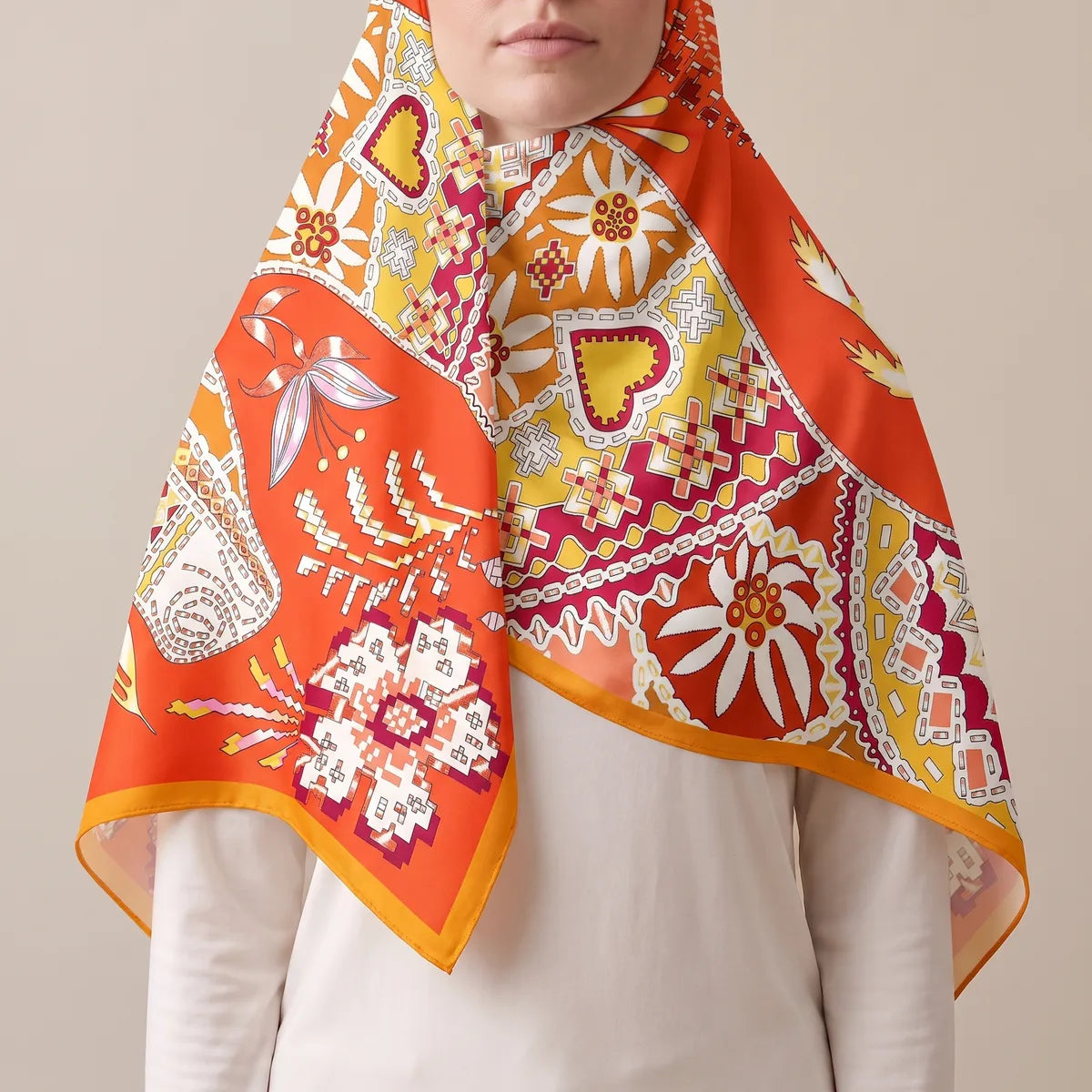 Orange and red silk shawl drawn over the head as a hood, the daisy panels falling open over a white top