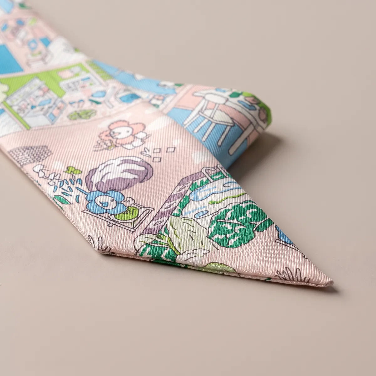 Tip of the pastel pink skinny scarf: smiling blue and pink flowers, a garden pool and green leaves