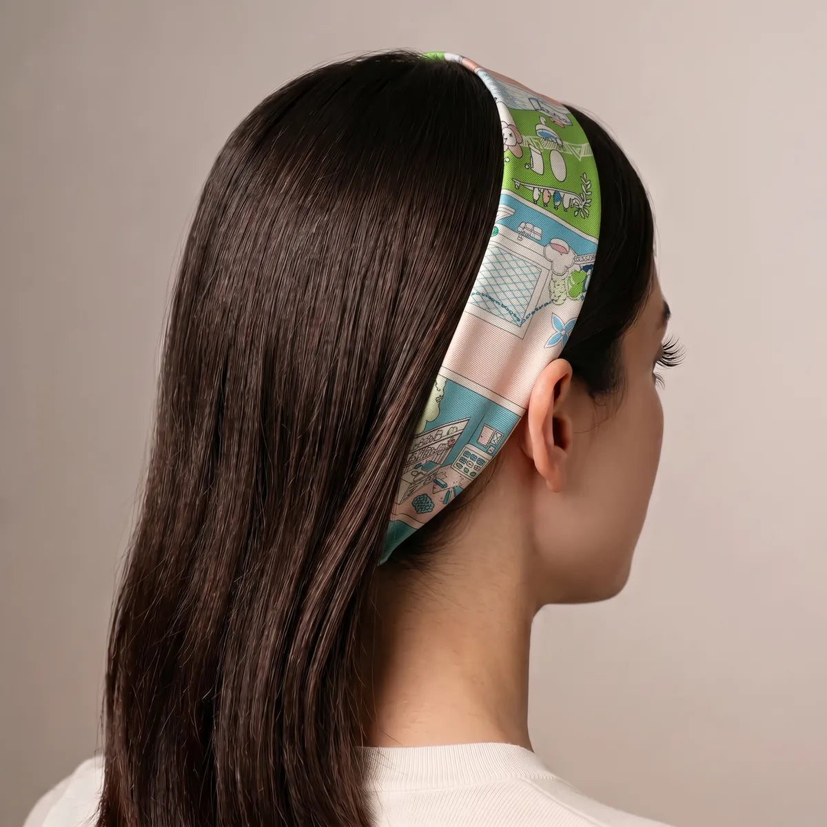 Pastel pink skinny scarf as a headband over long dark hair, lime room panels on top