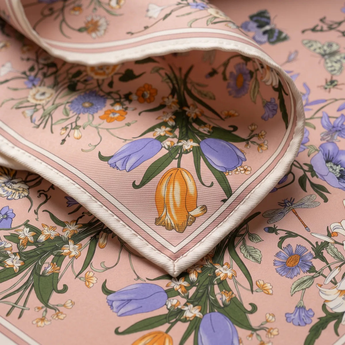 Corner of the pink shawl: an orange tulip and periwinkle tulips above the cream border