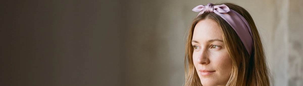 Woman wearing a lilac silk bandana as a knotted headband