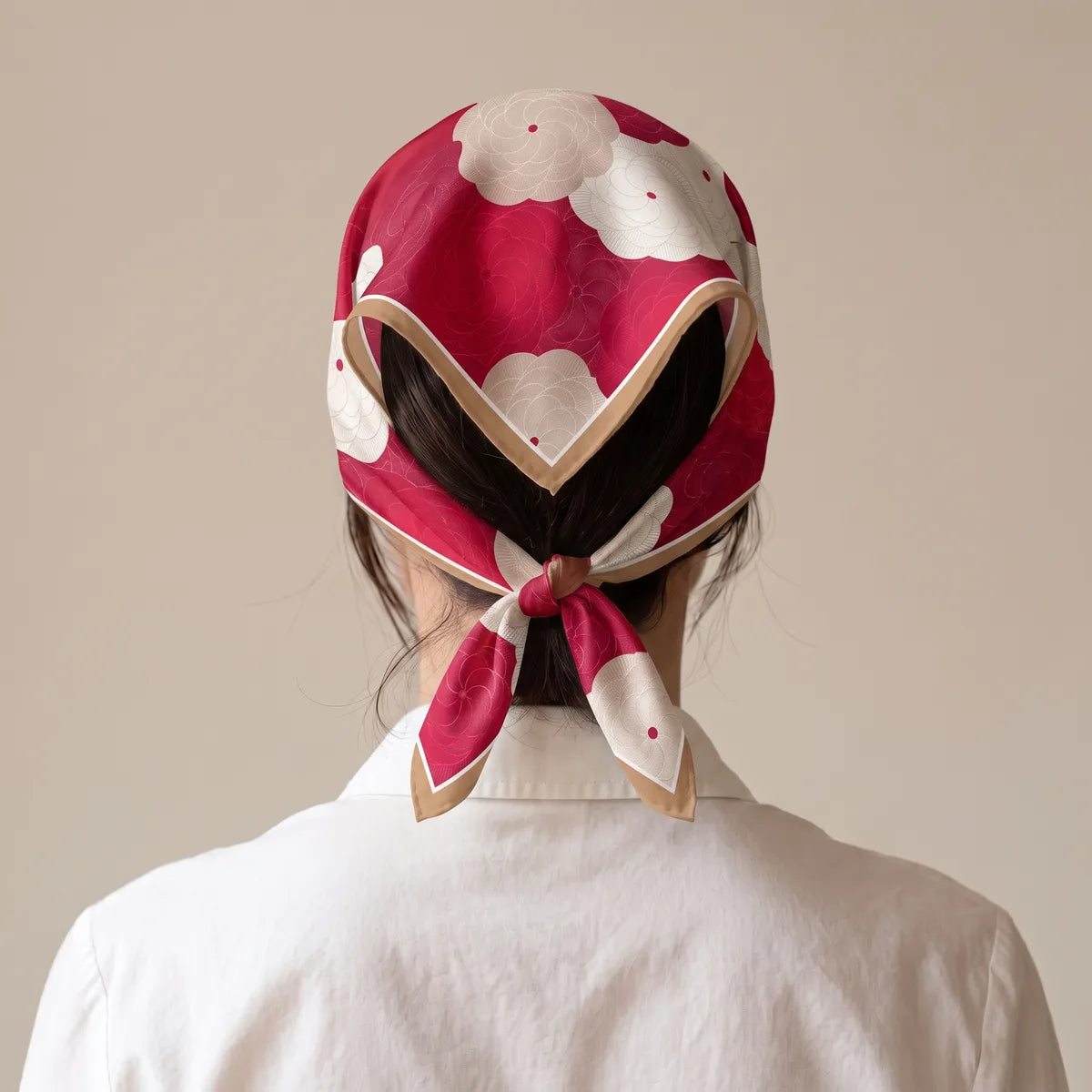 Back view of the red silk bandana over the hair, the tan border outlining a triangle above the nape knot