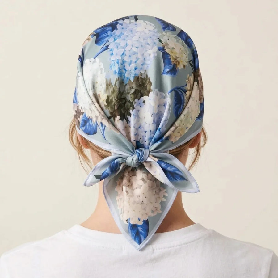 Hydrangea print silk bandana worn as a kerchief over the crown, knotted at the nape