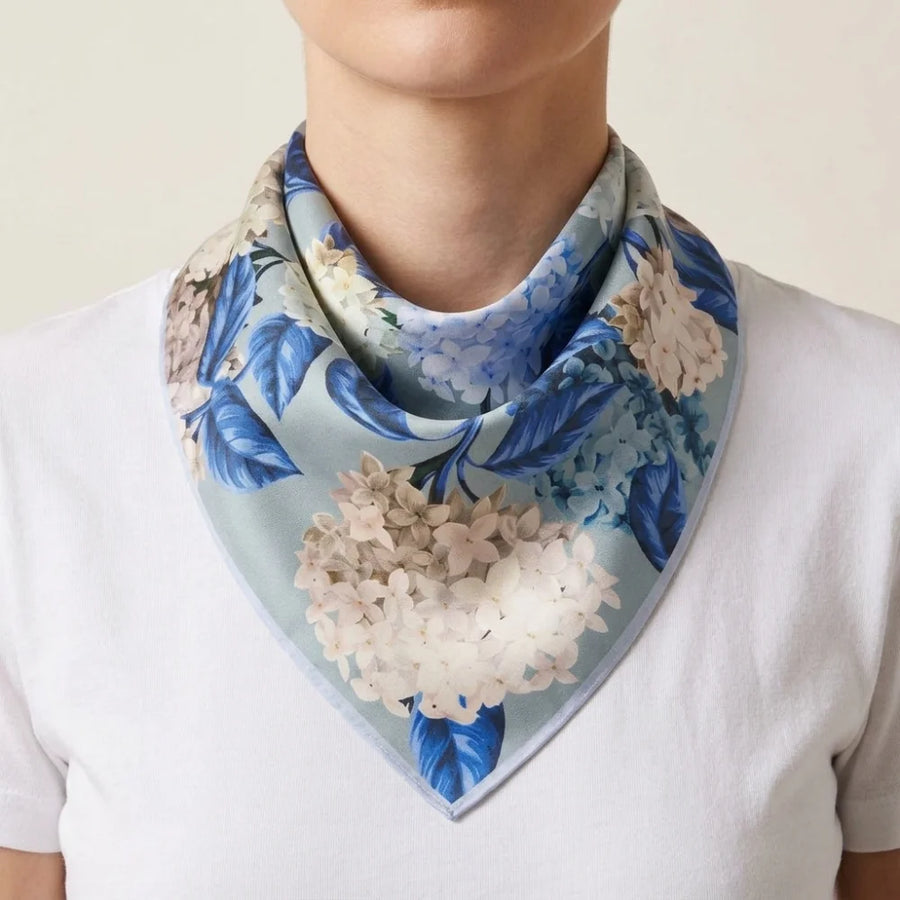 Hydrangea print silk bandana folded corner to corner and worn as a triangle at the neck