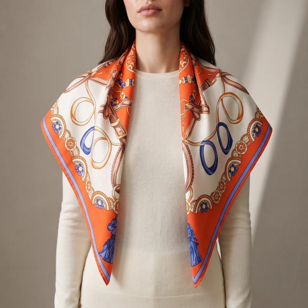 Orange chain print silk shawl draped over the shoulders