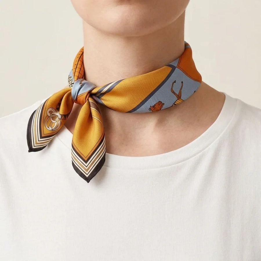 Horse print silk square scarf rolled into a band and knotted at the side of the neck