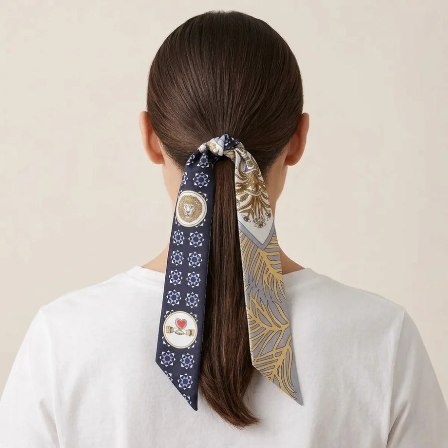 Navy medallion skinny silk scarf tied over a ponytail with the ends left long
