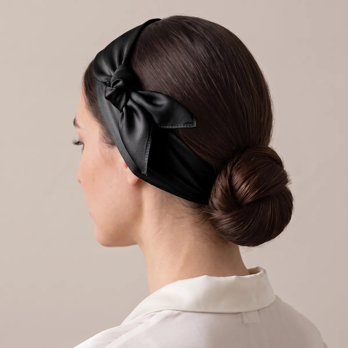 Black silk bandana as a headband, knot just above the ear, framing a low bun