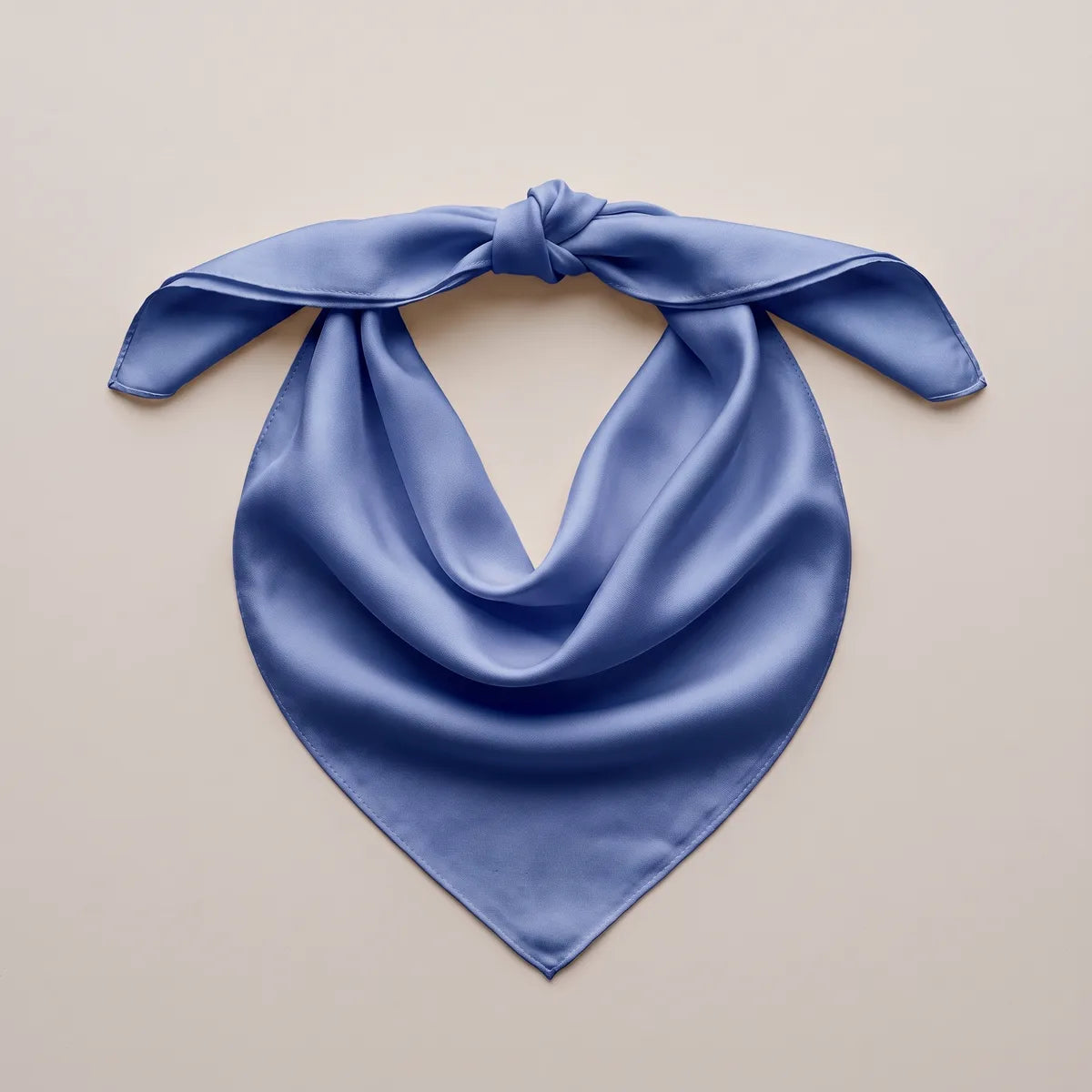 Periwinkle bandana tied at the top and spread out, its point hanging in a smooth V