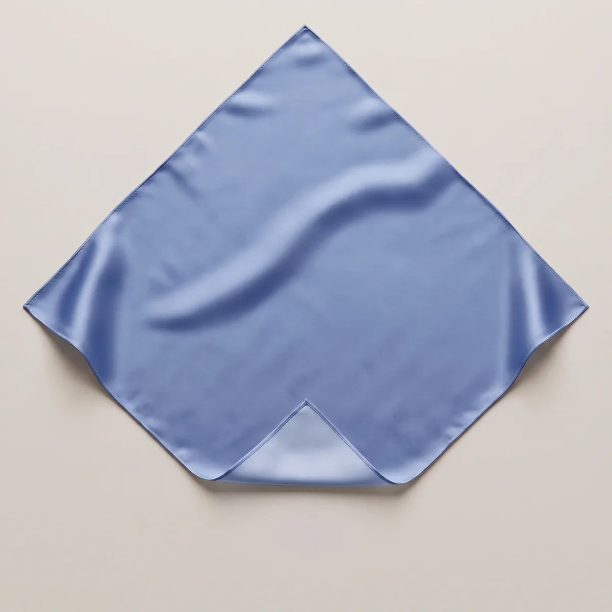 Solid blue silk bandana lying flat, point up, in even periwinkle with one corner folded back