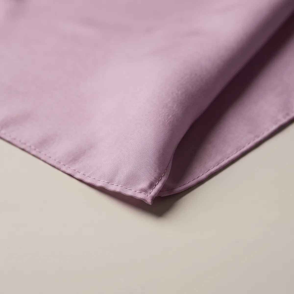 Detail of the lilac bandana corner, the narrow matching hem and fine silk texture