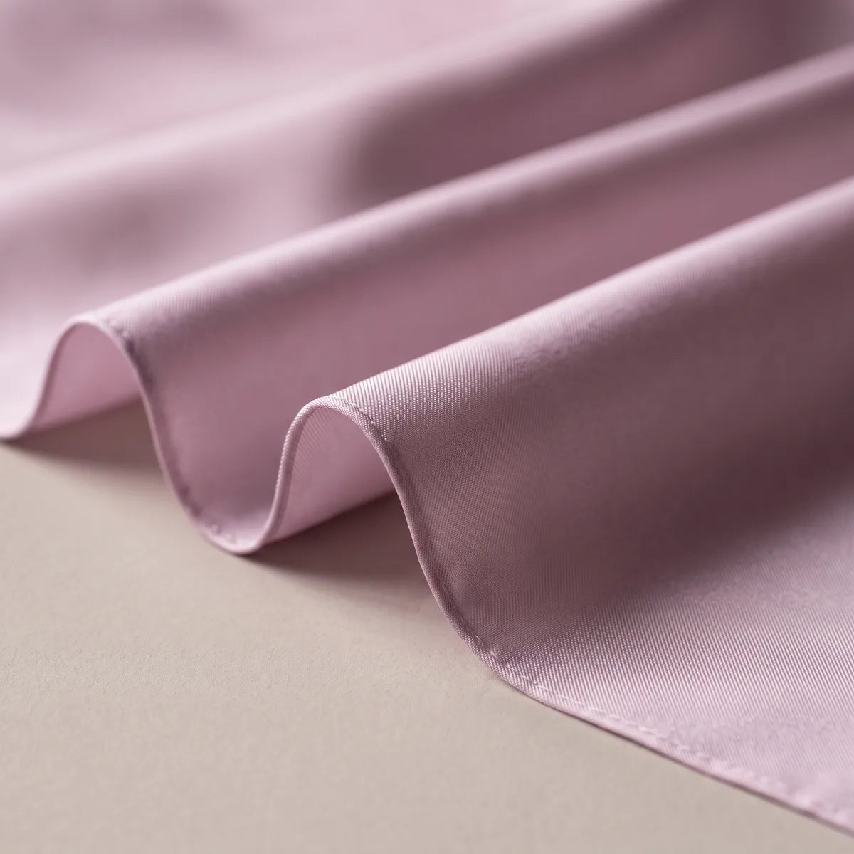Muted lilac silk in rippling folds, light catching along each ridge