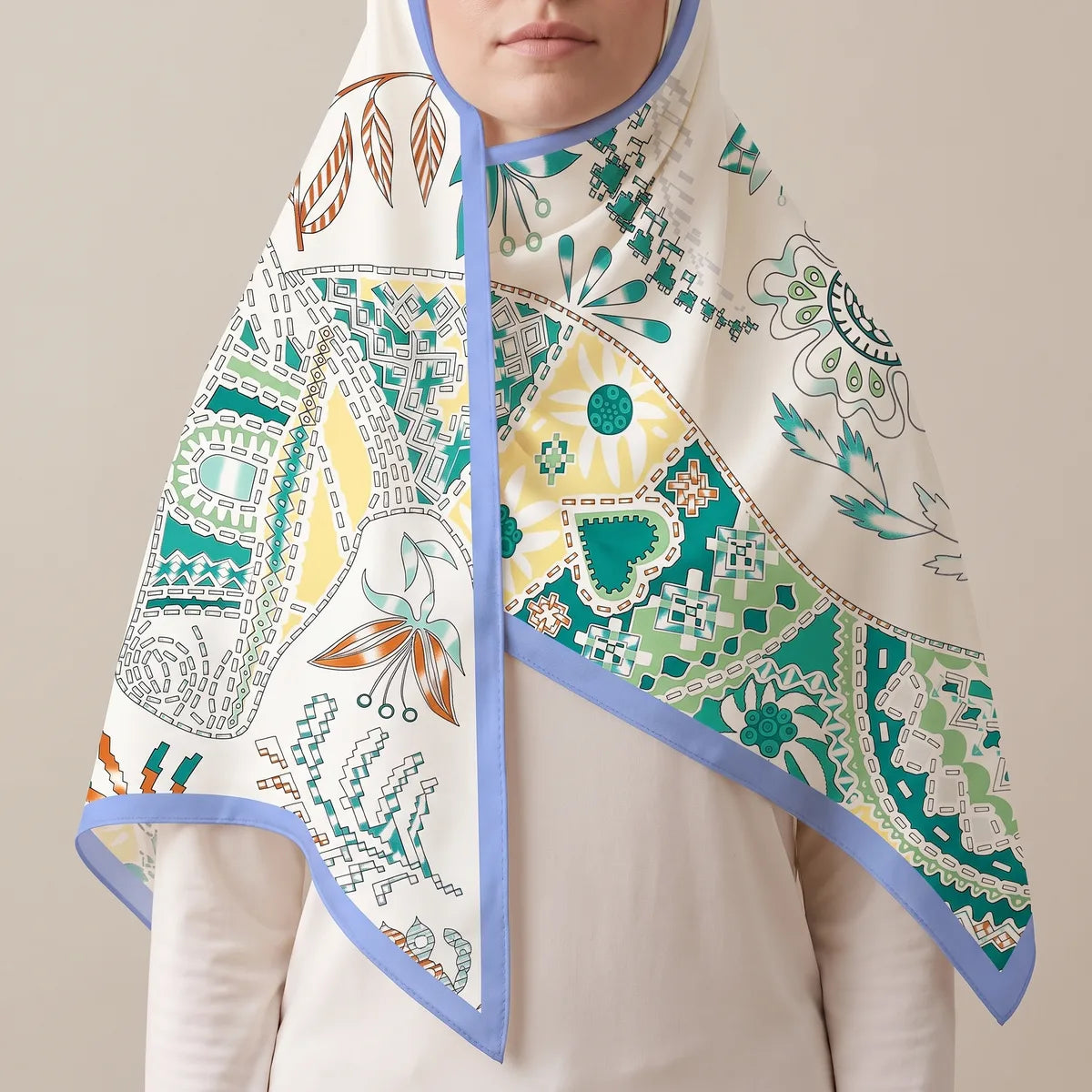 White patchwork silk shawl draped over the head and shoulders like a hood, rust leaves and teal patches
